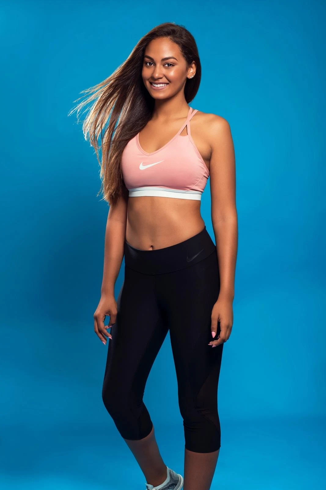 Activewear portrait against a bright blue background