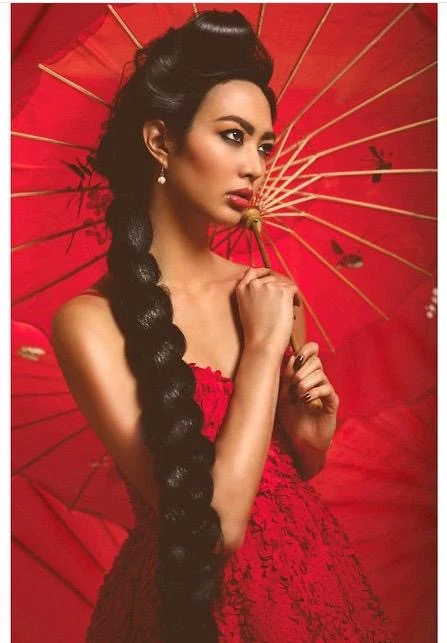 Beauty portrait framed by a red parasol